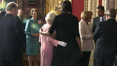 The Queen and Michelle Obama place their arms around each other at Buckingham Palace reception in 2009