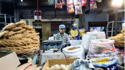 A Muslim boy in a sweet shop