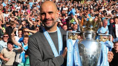 Pep Guardiola holds the trophy