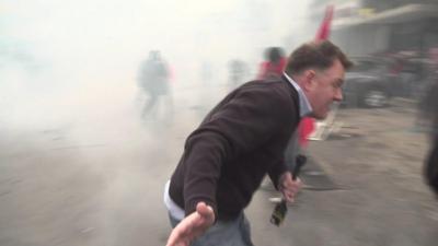 BBC correspondent Martin Patience flees tear gas