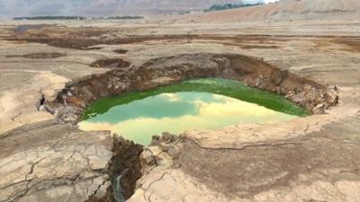 A sinkhole measuring about 40m-50m (130ft - 160ft) in diameter