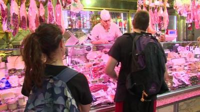 People shopping in butchers