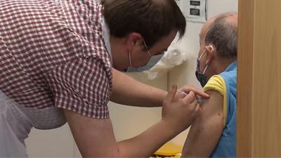 man receiving vaccine at pharmacy