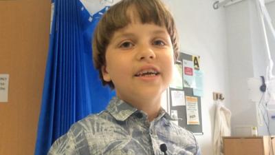 Singing boy makes hospital patients smile