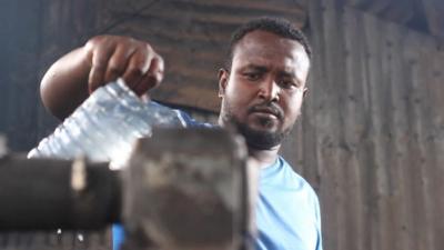 picture of man pouring water into a generator