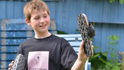 Young boy showing upcycled sandals