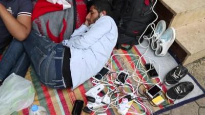 Refugees charging phones