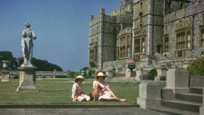 Queen Elizabeth II and Princess Margaret as children in front of Windsor Castle