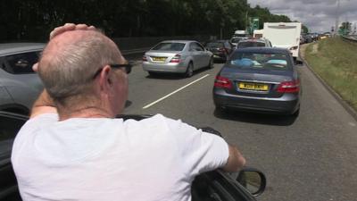 A frustrated driver looks at he traffic jam