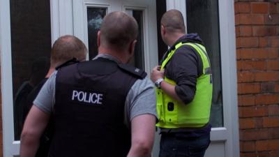 Police knocking on a door in Birmingham