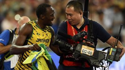 Bolt laughs with the cameraman after the fall