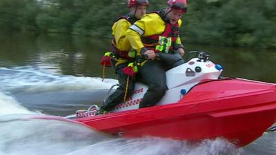 Two volunteer rescuers riding a Rescuerunner rescue boat