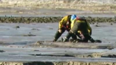 Boy being rescued from mud