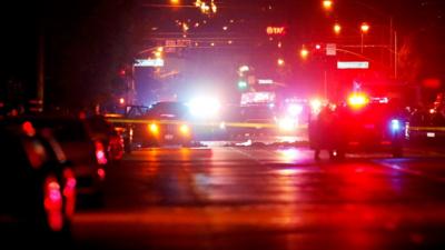 Police vehicles line the street around a vehicle in which two suspects were shot following a mass shooting in San Bernardino, California December 2, 2015