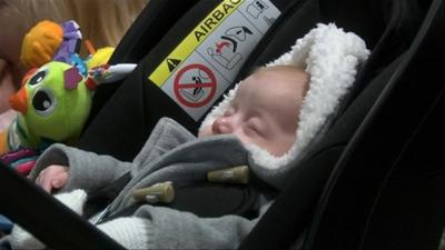 Newborn baby sleeping in a pram