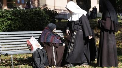 People shelter in a park in Norcia