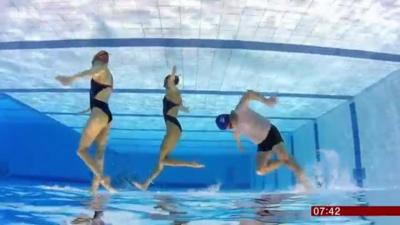 Mike Bushell trying out sychronised swimming with two professionals for BBC Breakfast