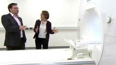 Dr Claudia Metzler-Baddeley with one of the new brain scanners