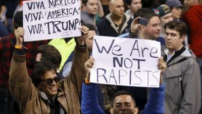 Demonstrators hold signs and cheer after Republican US presidential candidate Donald Trump cancelled his rally at the University of Illinois at Chicago March 11, 2016