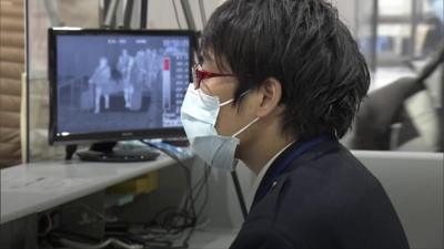 Airport official wearing face mask