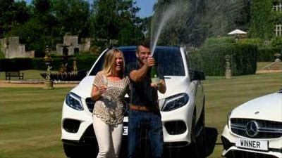 Lottery winners shaking a bottle of champagne