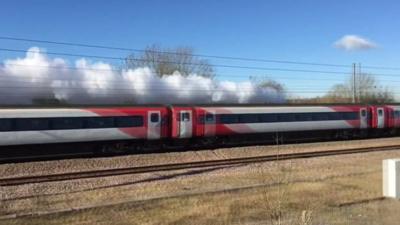 Flying Scotsman obscured by a Virgin train