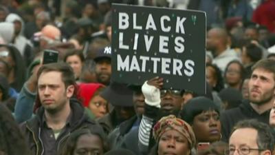 Protestor carries a banner in Ferguson