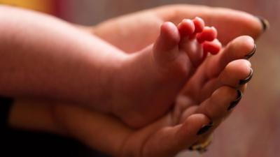 Child's foot being held