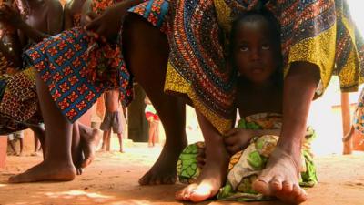 Child watching voodoo ceremony