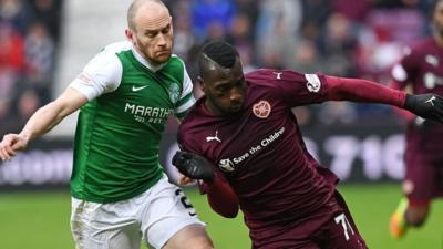 Hibernian's David Gray challenges Hearts' Esmael Goncalves