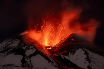Mount Etna: Volcano sprays lava into Sicily's night sky