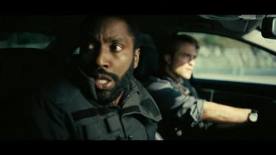 A scene from Christopher Nolan's Tenet - John David Washington and Robert Pattinson are in a car