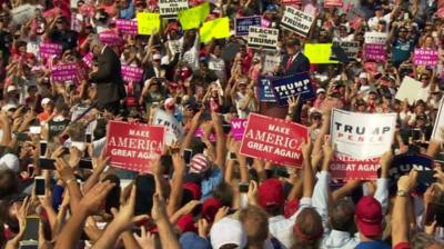 With under a fortnight to go until the election, Donald Trump attends the opening of his DC hotel.