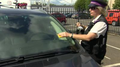 Traffic warden issuing parking fine