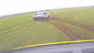 Driver pursued over fields