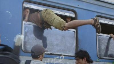 Migrant clambers on board through a narrow window