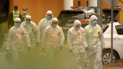 Men in hazmat suits