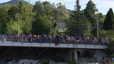 People being held back on the road crossing into Germany