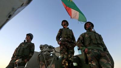 Peshmerga fighters in May waving a Kurdistan flag.