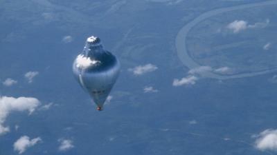 Balloon flying over landscape