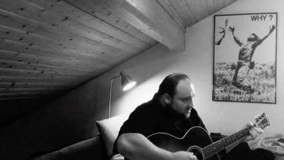 screen shot from a video showing musician Alex Diehl playing his song