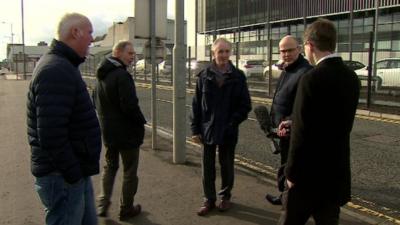 Chris Buckler speaking to staff outside the firm's Belfast premises.