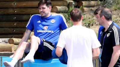 Northern Ireland striker Kyle Lafferty climbs into an ice bath after suffering an injury scare during training ahead of Sunday's Euro 2016 opener against Poland