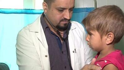 A doctor examining a child