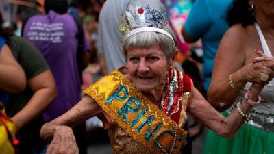 Revellers take part in a street carnival parade of the "Loucura Suburbana" in Rio de Janeiro, Brazil