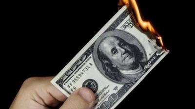 a dollar bill on fire