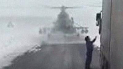 A military helicopter lands on a road in Kazakhstan after the pilot lost his bearings during an orientation exercise.