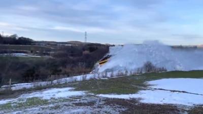 A train snowplough is filmed in action near Huntly.