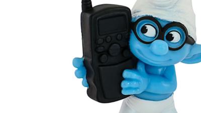 Smurf toy holding mobile phone