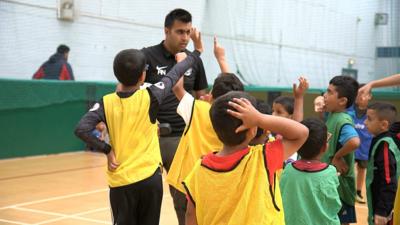 A volunteer coach at the Manningham Football Academy in Bradford